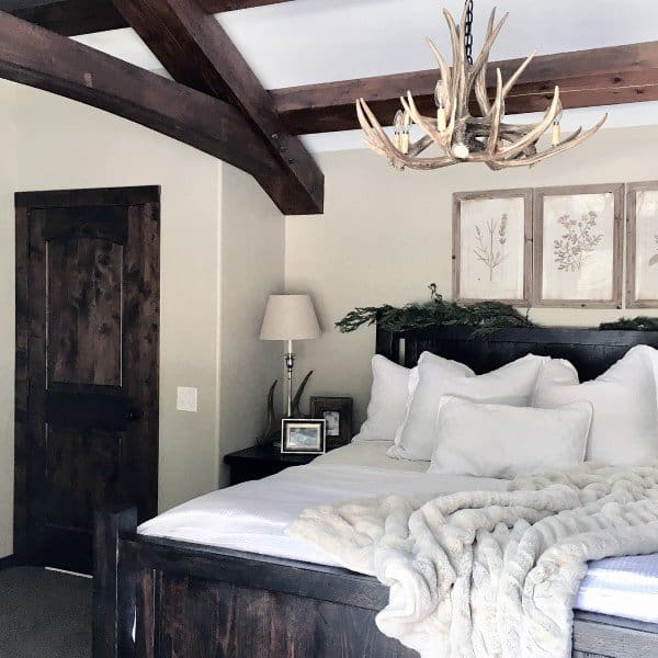 rustic bedroom with exposed wood ceiling
