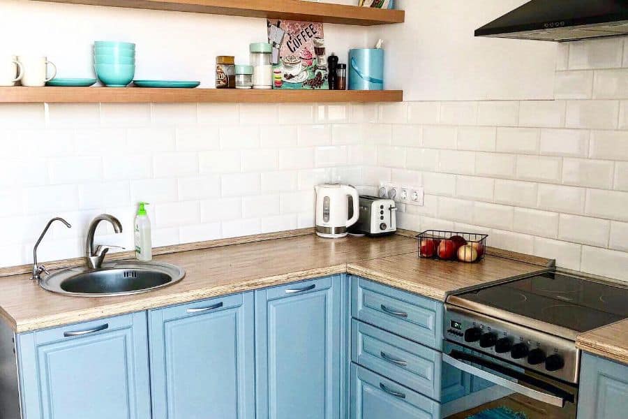 traditional small corner kitchen with blue cabinets