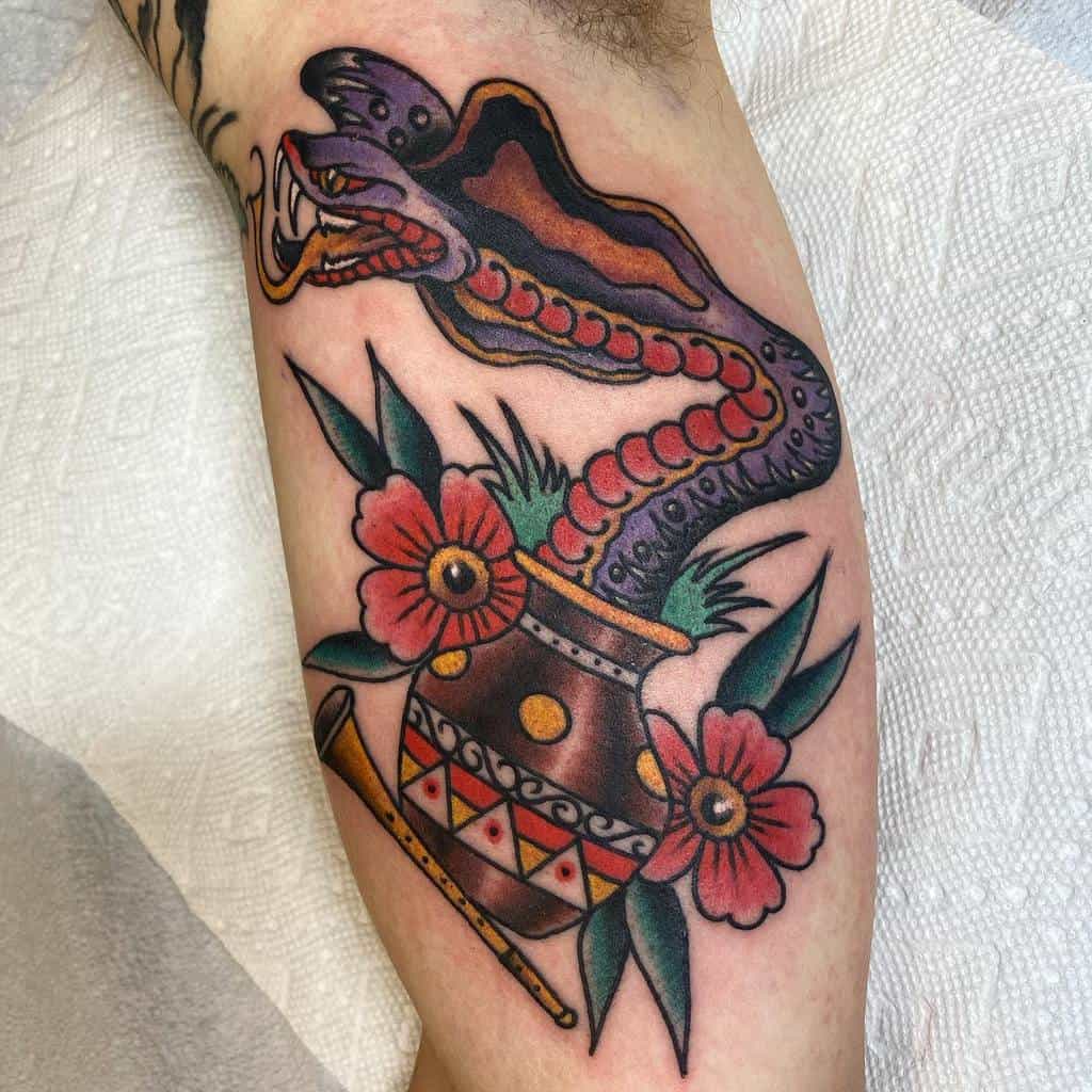 Colorful tattoo of a cobra, flowers, and a patterned pot on an arm