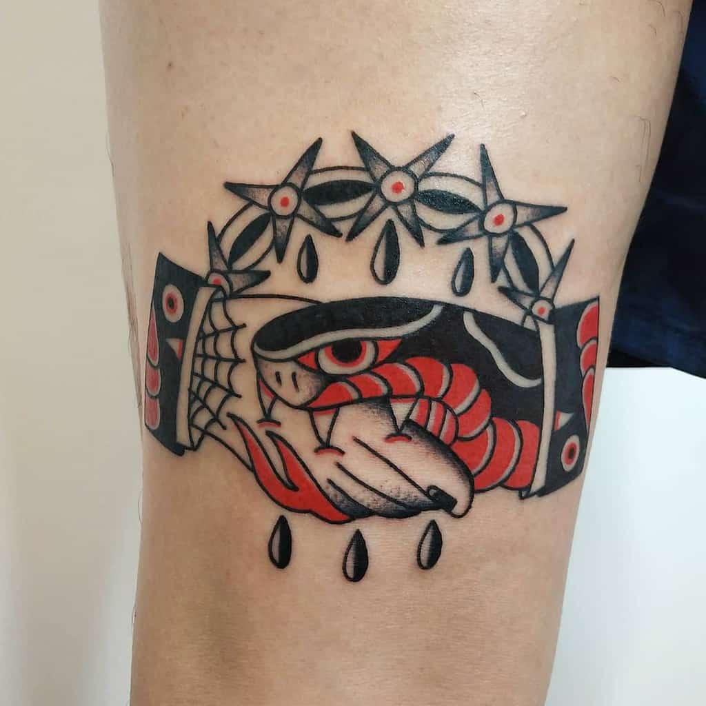 Bold traditional tattoo design featuring a handshake with a coiled snake and sharp barbed wire, accentuated by striking red and black details