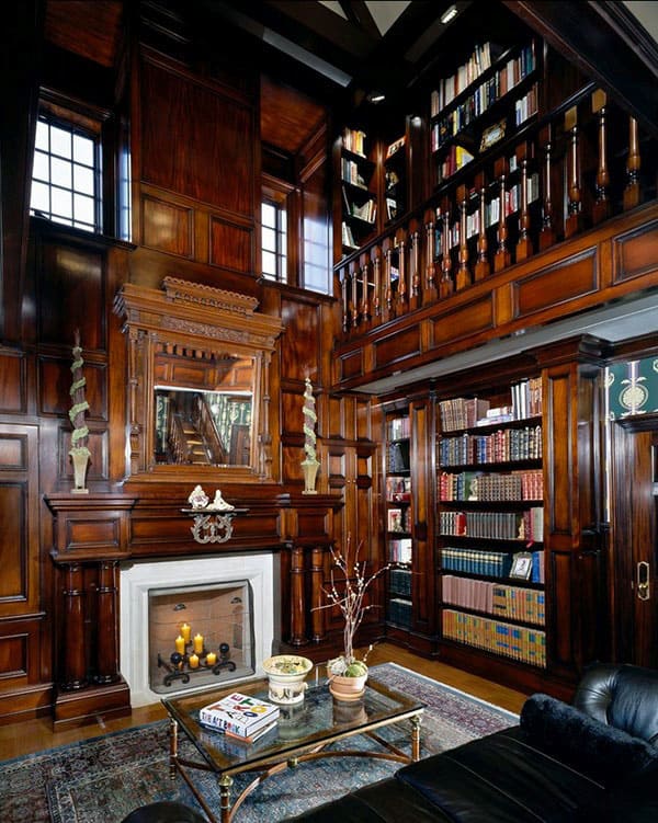 Luxurious library with wooden panels, bookshelves, a fireplace, leather seating, and a carpeted floor