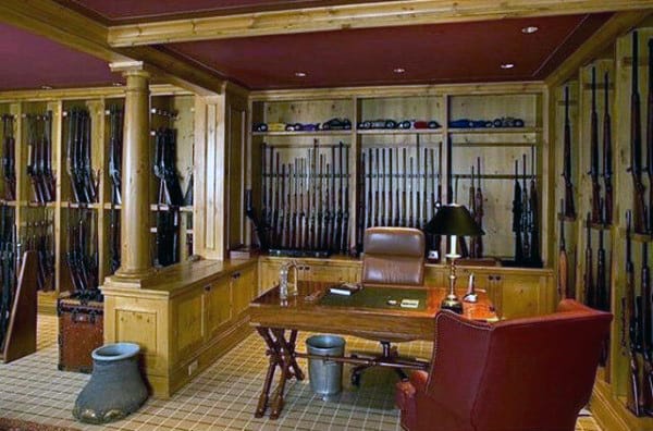 Traditional gun room featuring wooden cabinetry, a leather office chair, and a central desk for workspace functionality.