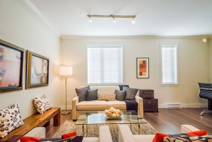 family room framed wall art bench seat glass table track lighting 