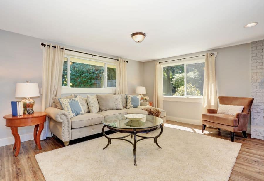 family room gray sofa glass table wood floor 