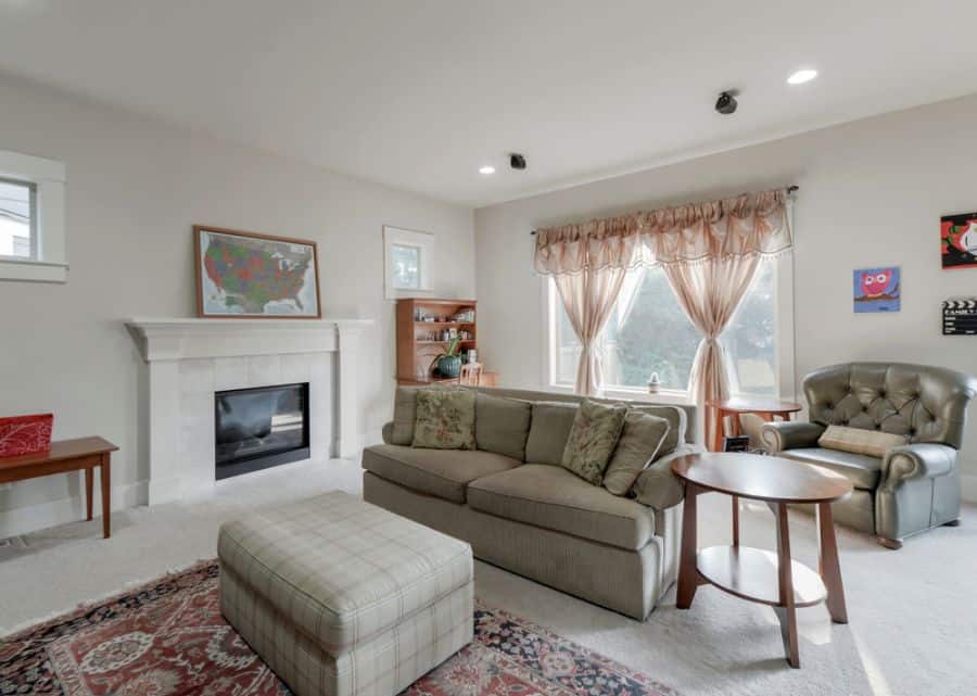 living room fireplace gray sofa brown table ottoman 