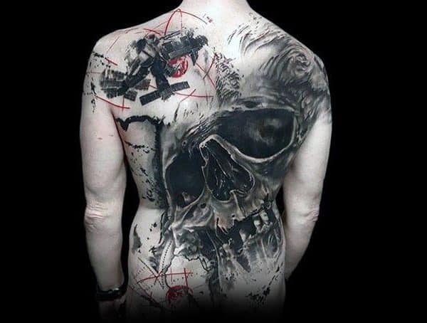 Black and grey full-back tattoo featuring a large skull with abstract elements, red geometric accents, and a grunge-style composition for a dark, artistic look.