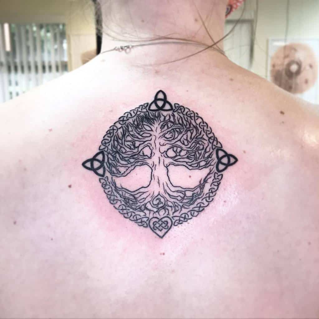 Intricate Celtic-inspired tree tattoo featuring triquetra symbols, representing balance, unity, and the cycle of life and nature
