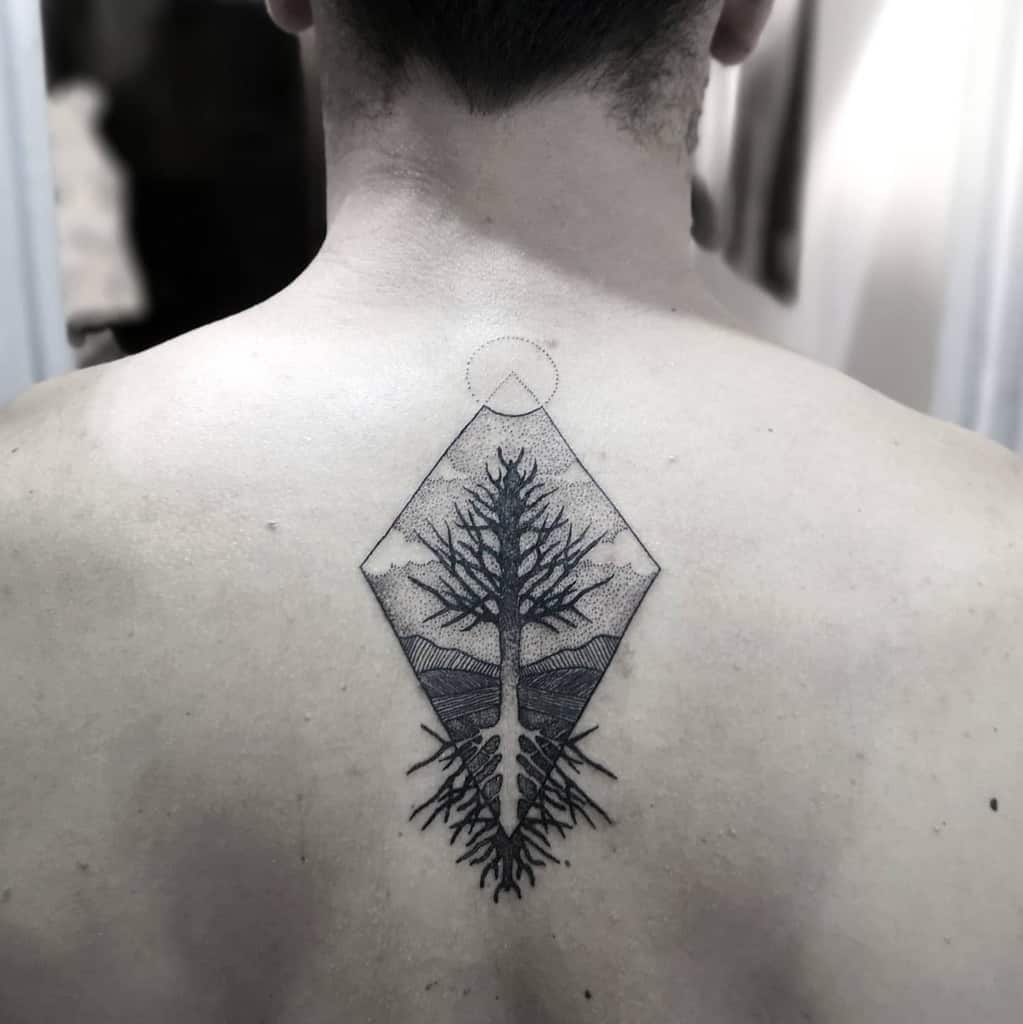 Back tattoo of a geometric tree with branches and roots enclosed in a diamond shape