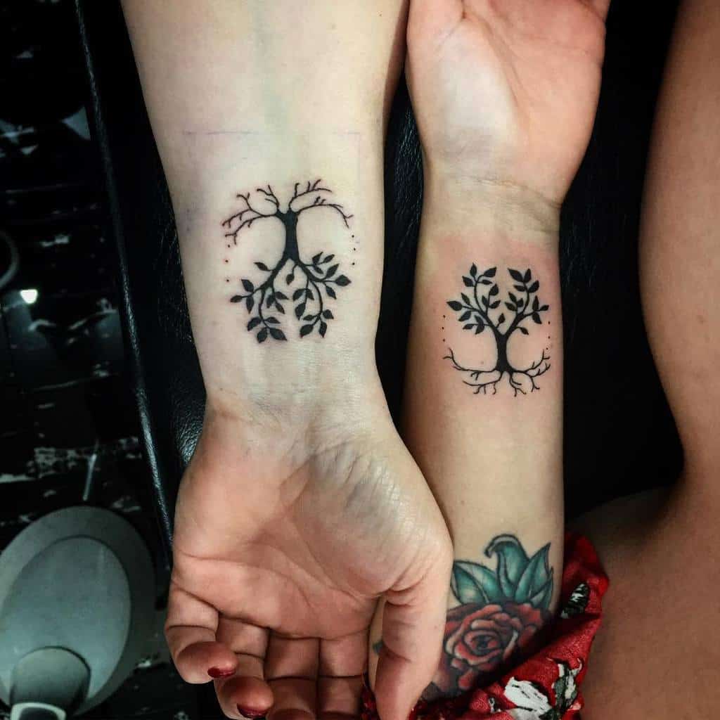 Mother-daughter matching tree with roots tattoo in silhouette, with six dots