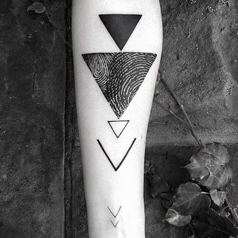 Forearm tattoo with geometric designs and a fingerprint pattern