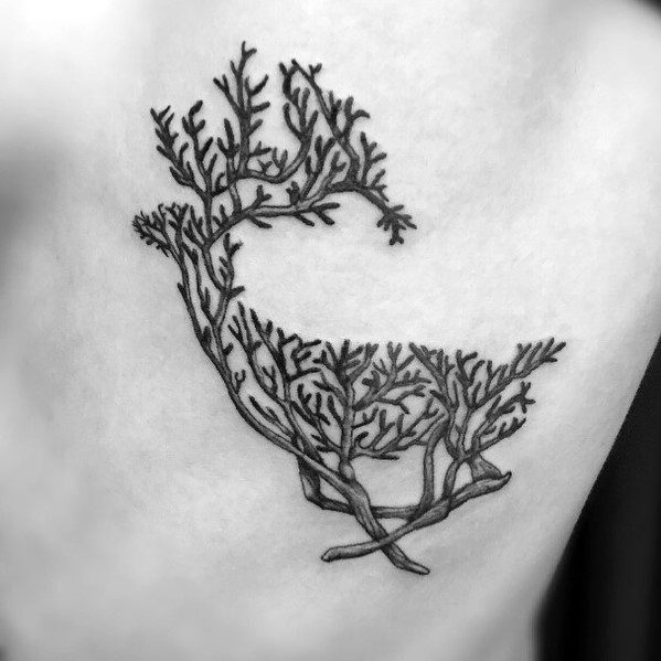 Minimalist black ink elk tattoo with antlers transforming into tree branches, featuring fine linework for a unique and nature-inspired design.