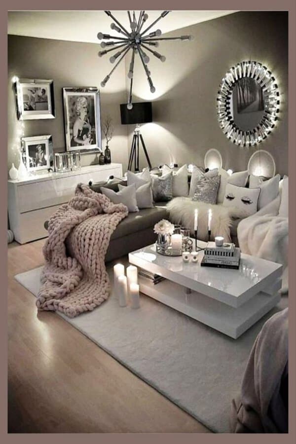 Chic grey and white living room with cozy textures, soft lighting, and stylish decor.