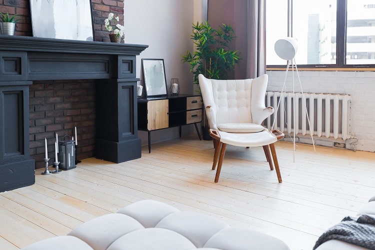 simple apartment with bricked up fireplace and black mantle