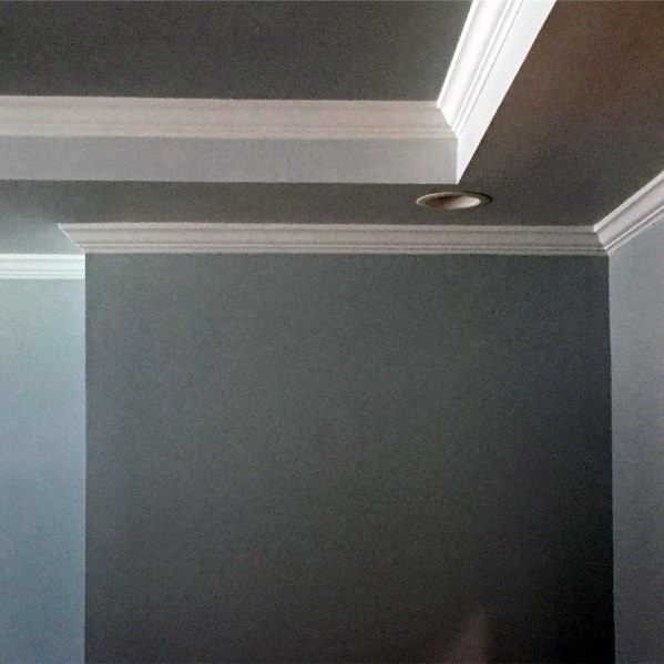 Elegant room with a trey ceiling, featuring clean white crown molding and subtle recessed lighting, creating a sophisticated atmosphere