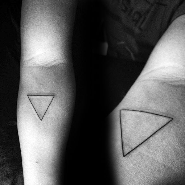 Black triangle tattoo on a forearm