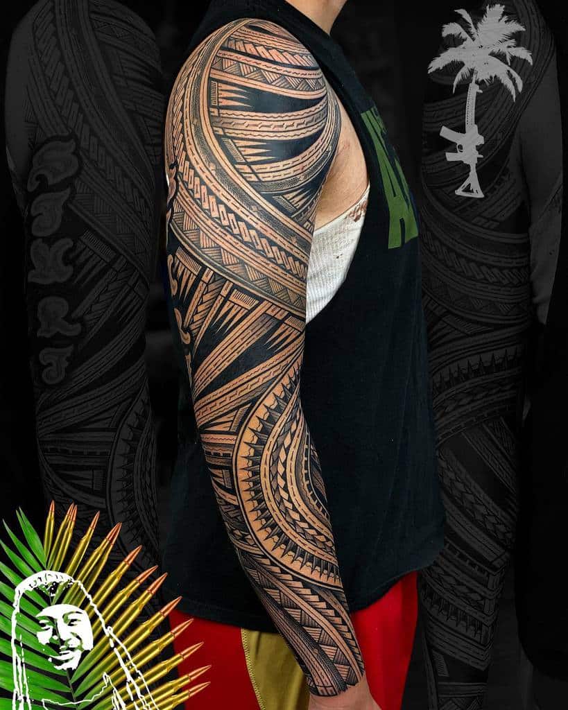 A man with a detailed Polynesian tribal full sleeve tattoo