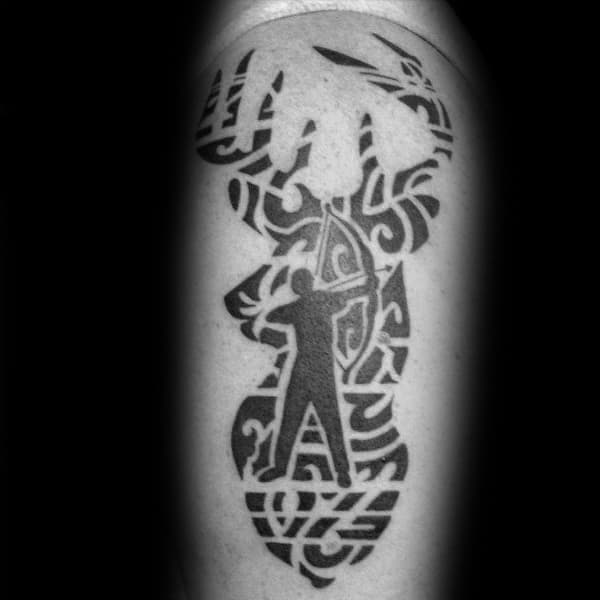 Bold black tribal-style tattoo of a deer head silhouette filled with intricate patterns and a central figure of a bowhunter aiming upward.