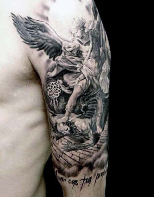 Black and white angel tattoo on an arm with detailed wings and a fallen figure below