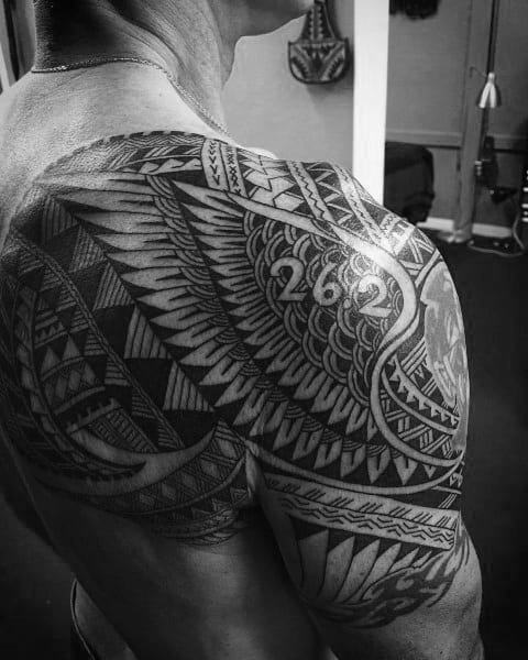 Intricate tribal-style shoulder tattoo with “26.2” embedded in the design, blending cultural art with marathon achievement.