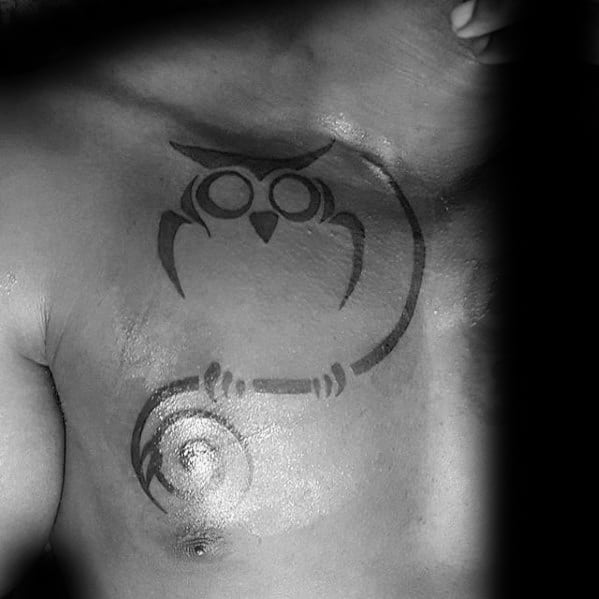 Tribal Owl Sitting On Tree Branch Guys Chest Tattoo