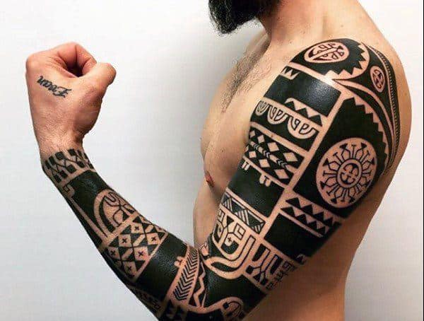 Polynesian tribal tattoo sleeve featuring bold black geometric patterns and intricate symbols, covering the arm and shoulder in a traditional style.