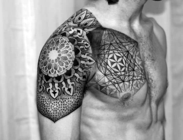 Chest and shoulder tattoos with geometric and intricate mandala designs on a shirtless person