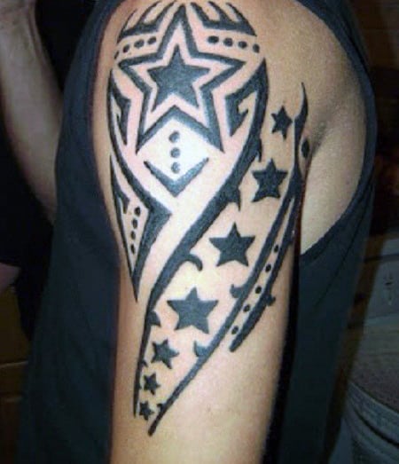 Arm tattoo featuring a large star surrounded by smaller stars and abstract patterns