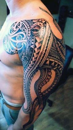 Person with an intricate tattoo design covering the shoulder and upper arm