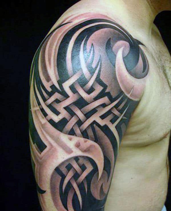 Tribal tattoo design covering a man's upper arm and shoulder