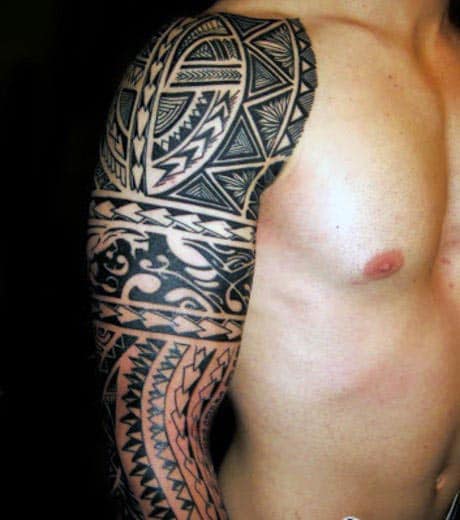 Man's shoulder and arm with intricate Polynesian tribal tattoo design