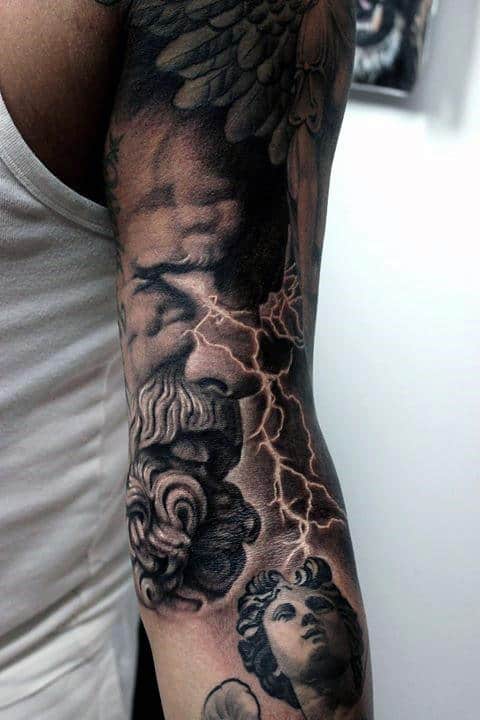 Detailed black-and-grey sleeve tattoo with storm clouds and lightning