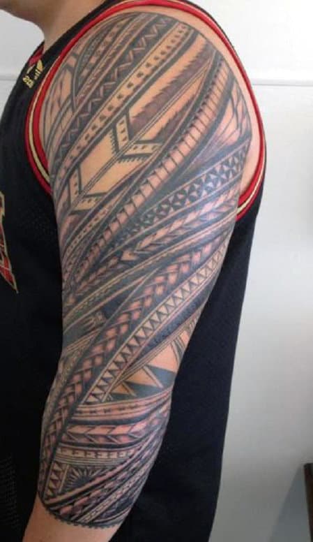 Person with a detailed geometric tattoo sleeve