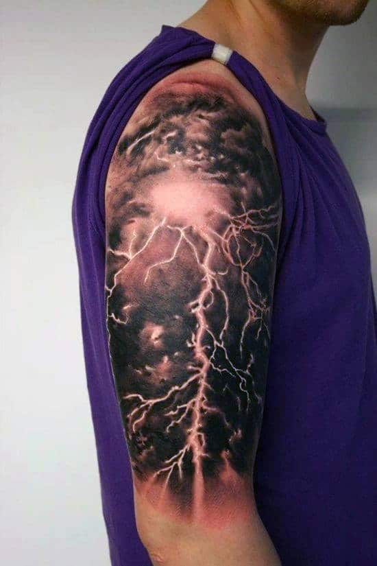 A man with a realistic lightning storm tattoo on his upper arm