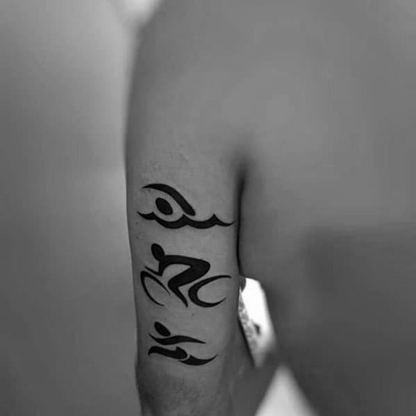 Triathlon tattoo with minimalist black icons representing swimming, cycling, and running, arranged in a vertical line along the forearm.
