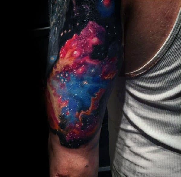 A colorful nebula tattoo on an arm, featuring galaxies and stars