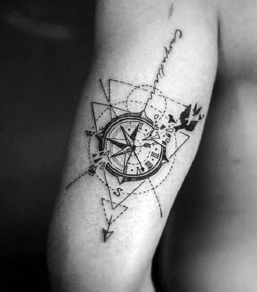Geometric compass tattoo with fine-line detailing, an arrow, and a bird, symbolizing direction, freedom, and the spirit of exploration.