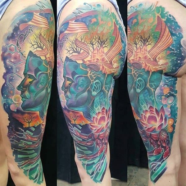Vibrant full-leg tattoo featuring a cosmic human profile, blooming lotus flowers, floating trees, and abstract dreamlike patterns.