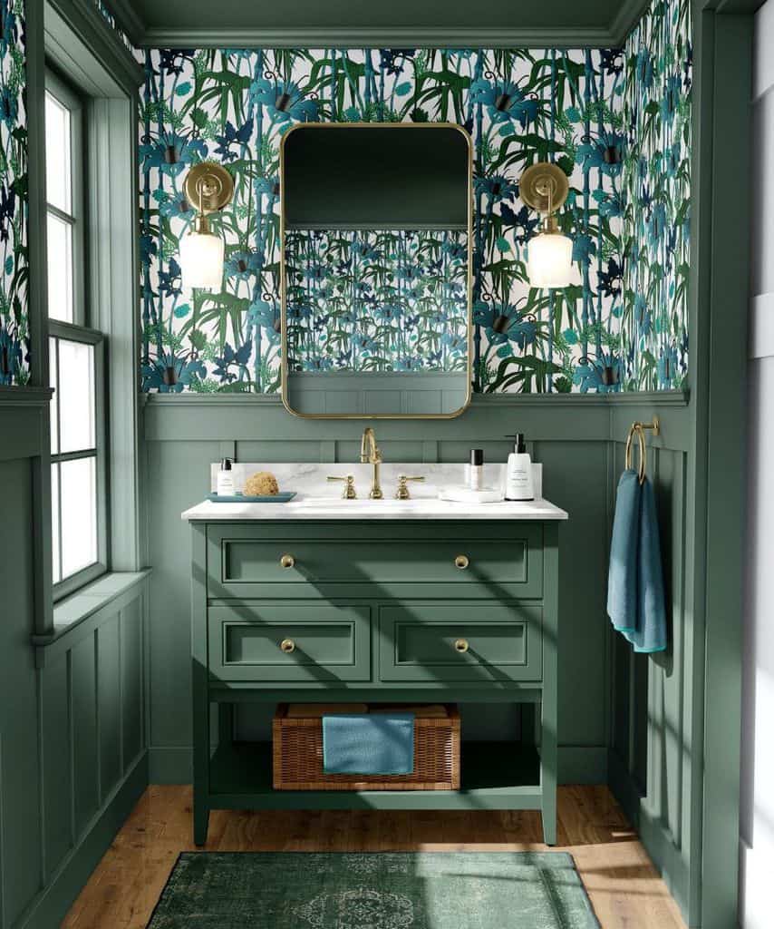Bathroom with floral wallpaper, green vanity, and gold fixtures.