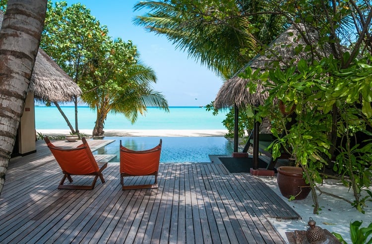 tropical landscape above ground infinity pool deck