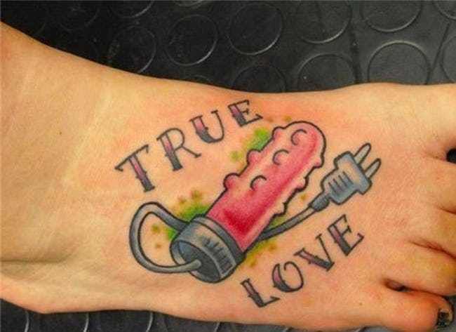 A colorful tattoo on the foot featuring an electric vibrator with the words 'TRUE LOVE' written around it in bold letters.