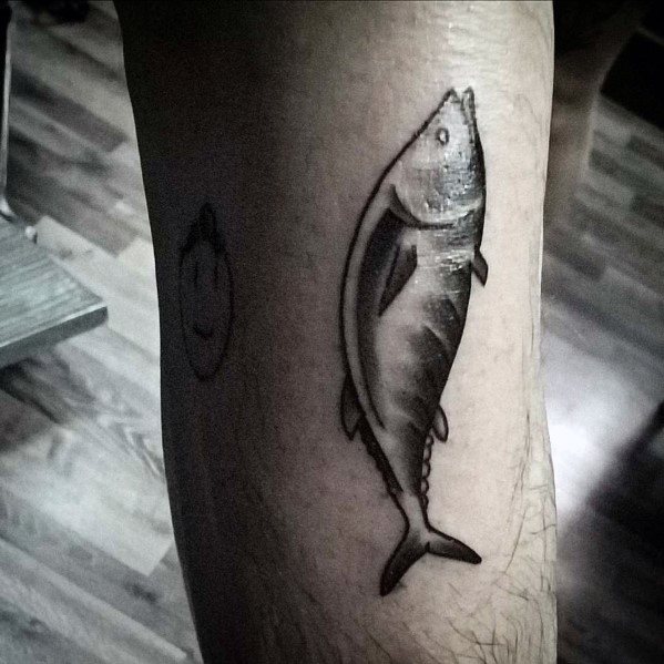 Minimalist black and grey tuna fish tattoo on a man's leg, featuring smooth shading and fine line details for a simple yet elegant design.