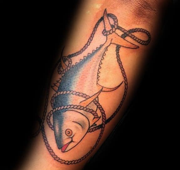 Traditional-style tuna fish tattoo on a man's forearm, featuring bold outlines, subtle shading, and a detailed rope design for a nautical theme.