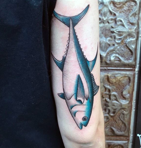Minimalist tuna fish tattoo on a man's forearm, featuring clean lines, subtle blue shading, and a sleek, modern ocean-inspired design.