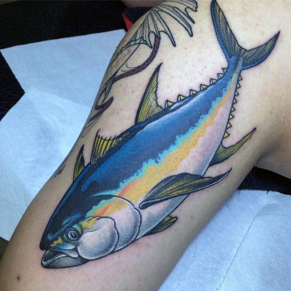 Realistic tuna fish tattoo on a man's arm, featuring vibrant blue and yellow hues, intricate shading, and fine details for a lifelike ocean-inspired design.