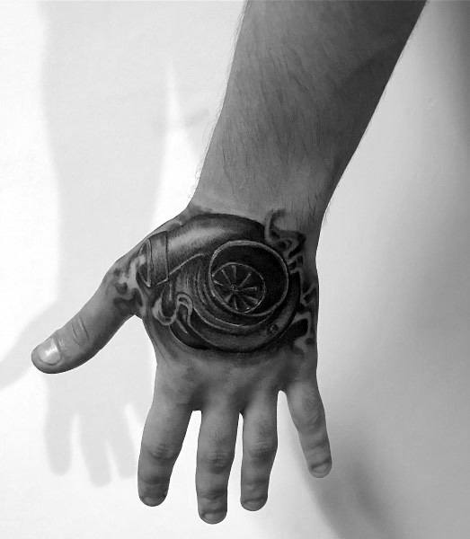 Realistic **turbocharger** tattoo on the hand with fine shading and intricate details, symbolizing speed, power, and a passion for automotive performance.