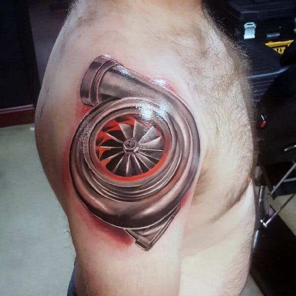 Realistic **turbocharger** tattoo on the upper arm with **metallic shading and red-hot turbine accents**, symbolizing speed, power, and automotive passion.