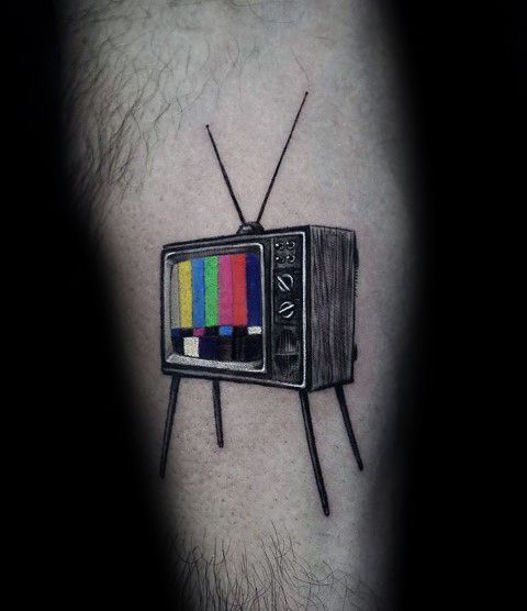 Tattoo of a vintage TV with a colorful test pattern on the screen, featuring fine black and grey shading, long antennas, and a classic mid-century design.