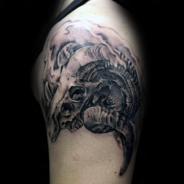 Twisted Ram Horns Skull Upper Arm Shaded Tattoo On Male