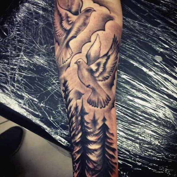 Two Doves Tattoo For Men Flying Over Pine Trees