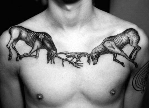 Black and grey chest tattoo of two skeletal elk locking antlers, featuring bold shading and intricate details for a striking and symbolic design.